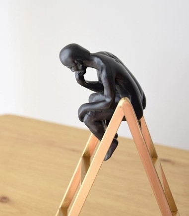 Figura de PENSADOR sobre escalera - VP Interiorismo
